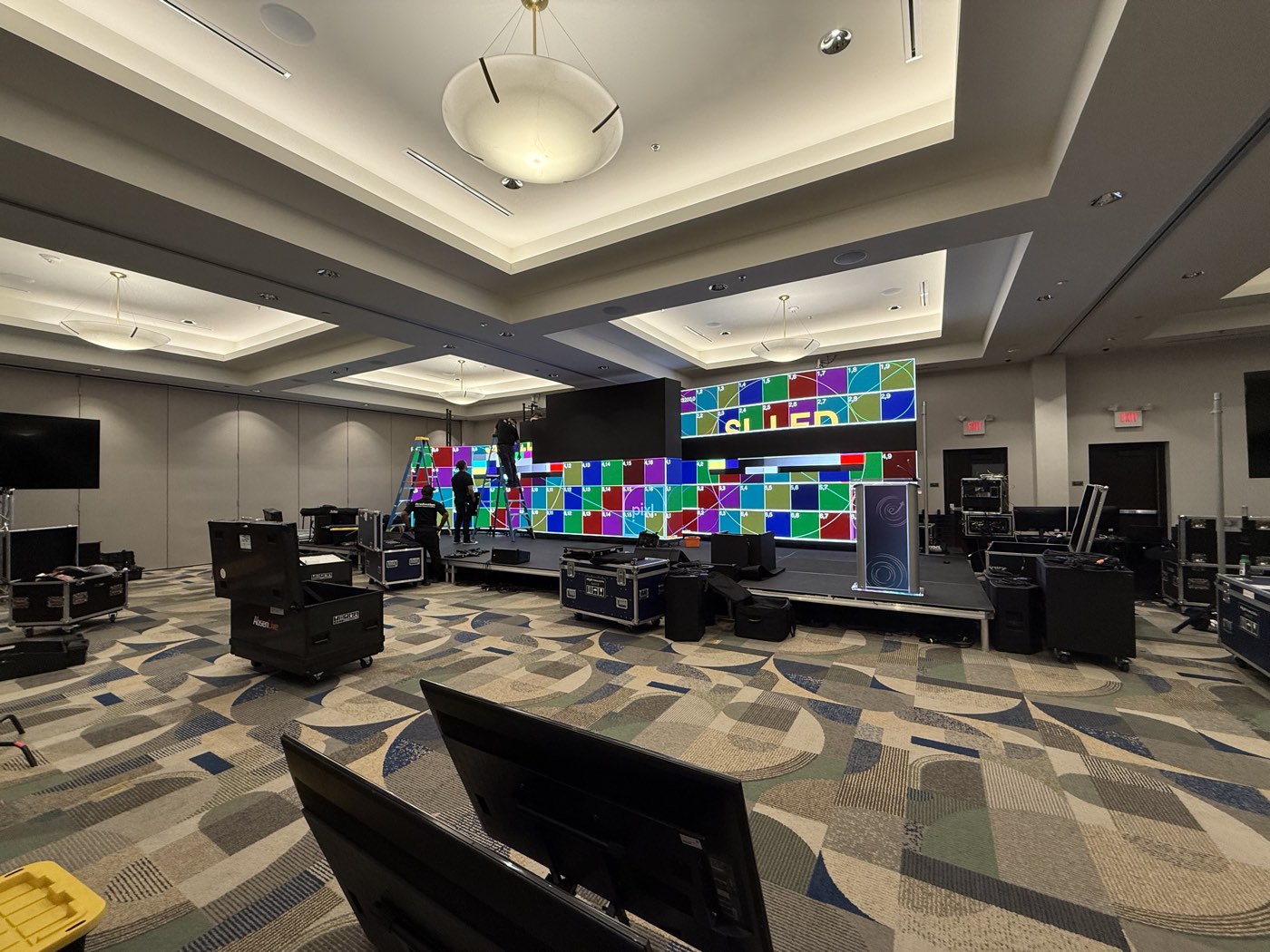 Wall during setup with test pattern and road cases